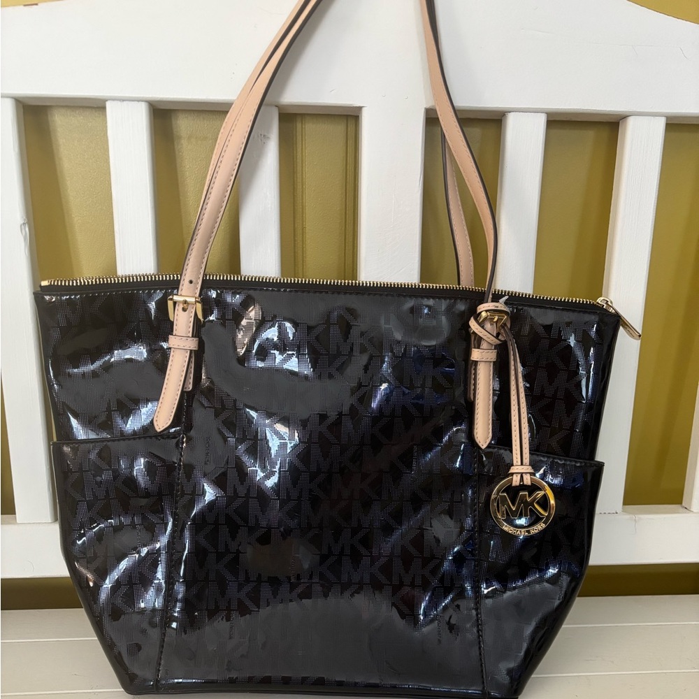 Michael Kors black patent leather shoulder bag with beige straps.